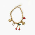 Bracelet cerises rouge et doré avec charms